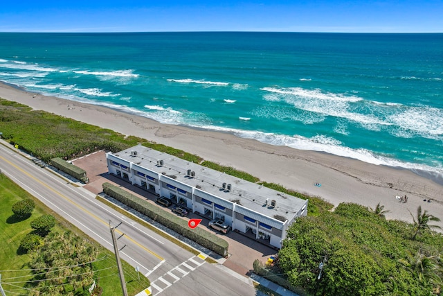 drone / aerial view with a water view and a view of the beach