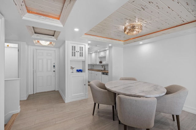 dining area featuring light hardwood / wood-style flooring, wooden ceiling, a tray ceiling, and sink