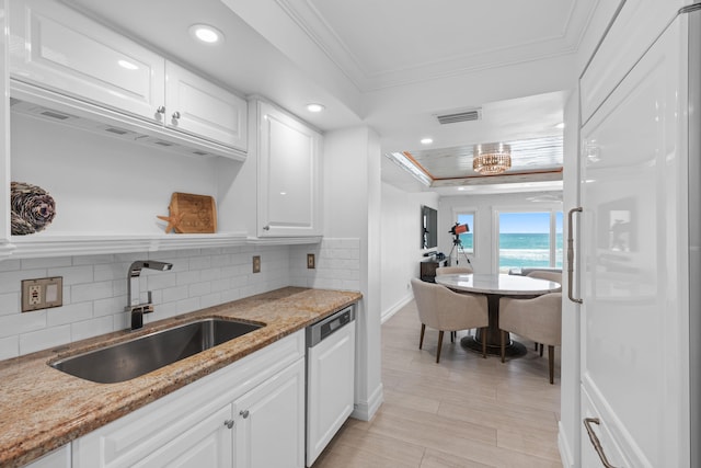 kitchen with white cabinets, light stone countertops, dishwasher, crown molding, and sink