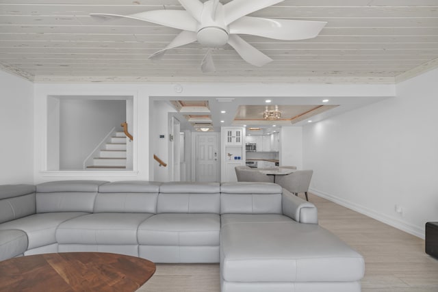 living room featuring crown molding and light hardwood / wood-style flooring