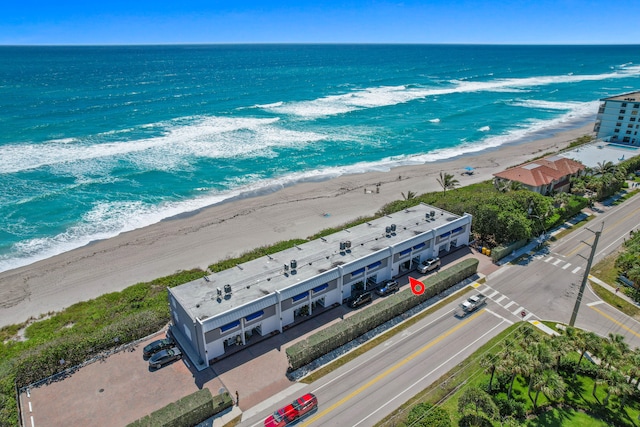 aerial view with a water view and a view of the beach