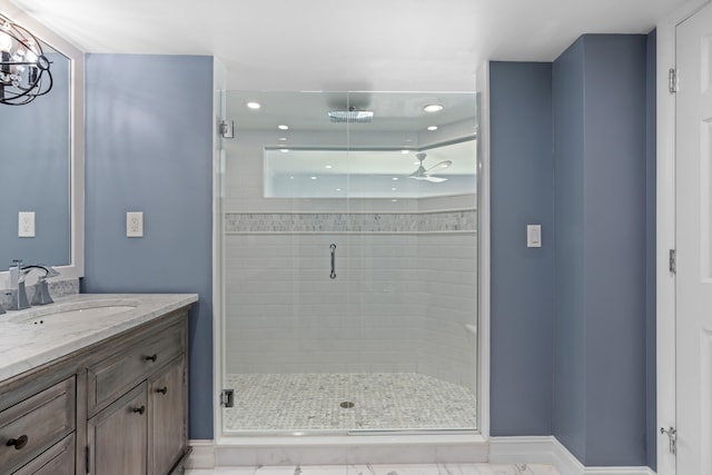 bathroom featuring vanity, ceiling fan, and walk in shower