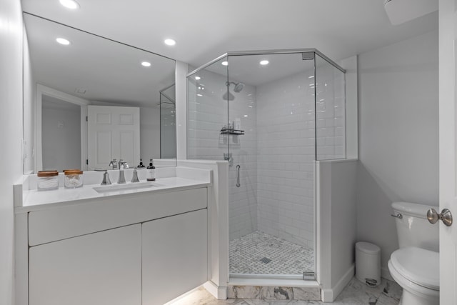 bathroom with vanity, toilet, and an enclosed shower