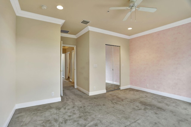 unfurnished bedroom featuring a closet, crown molding, light carpet, and ceiling fan