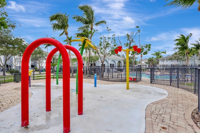 view of playground with a community pool