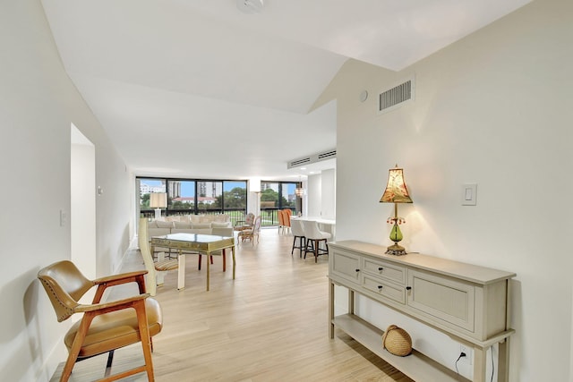 interior space with expansive windows and light wood-type flooring