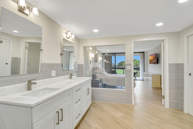 bathroom featuring vanity, tasteful backsplash, and wood-type flooring