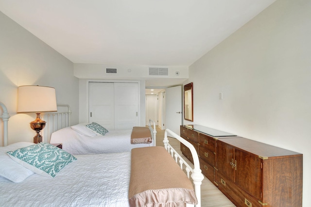 bedroom featuring a closet and light wood-type flooring