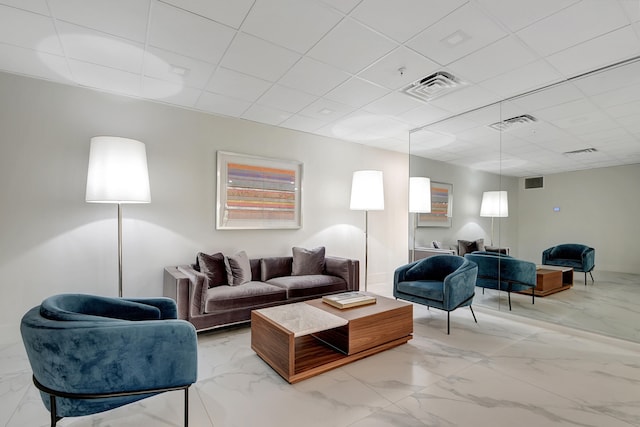 living room with a paneled ceiling