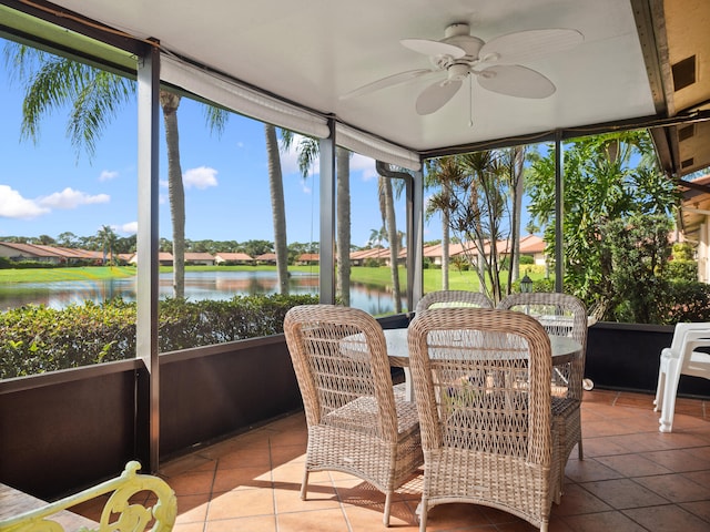 sunroom with a water view and ceiling fan