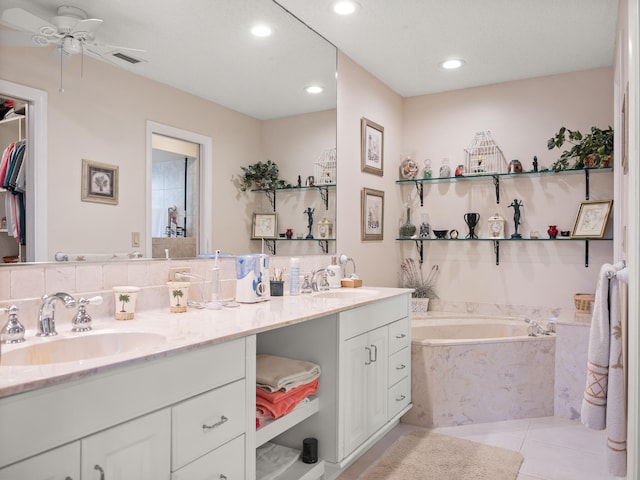 bathroom featuring decorative backsplash, ceiling fan, vanity, tile patterned floors, and tiled bath