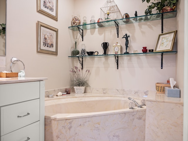 bathroom with vanity and tiled bath