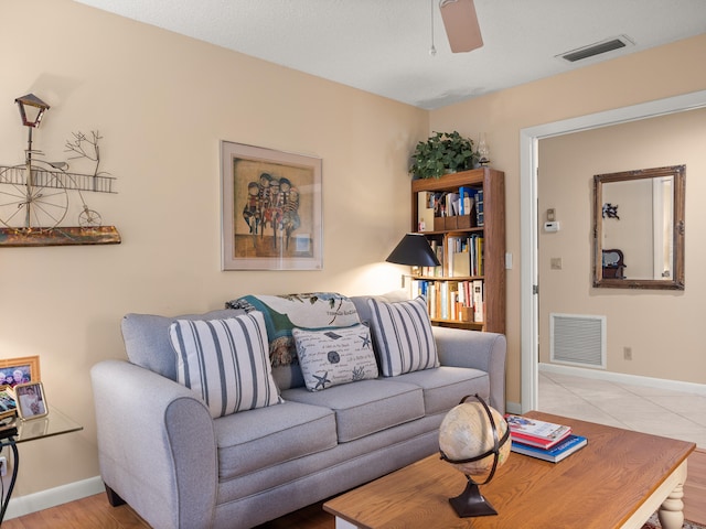 living room featuring ceiling fan and light hardwood / wood-style flooring