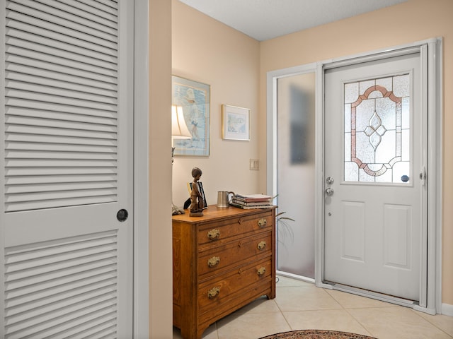 foyer entrance featuring light tile patterned floors