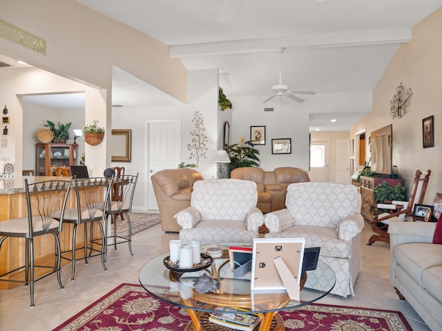 living room featuring lofted ceiling with beams, light tile patterned floors, and ceiling fan