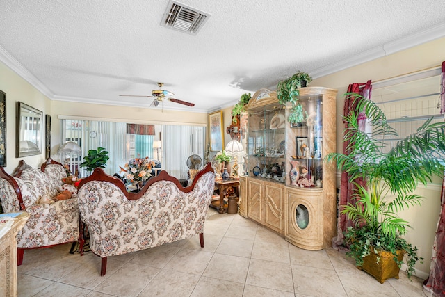 living room featuring ornamental molding, a textured ceiling, light tile patterned floors, and ceiling fan