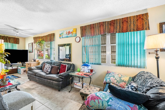 living room featuring ceiling fan, a textured ceiling, and light tile patterned flooring