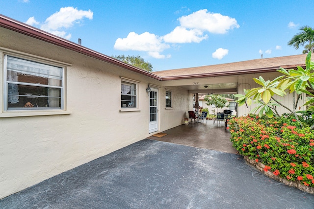 entrance to property featuring a patio