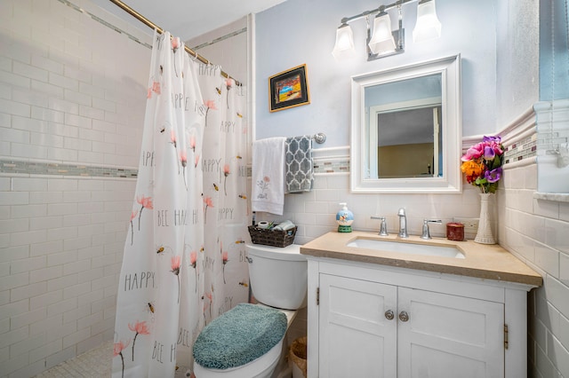 bathroom with tile walls, vanity, a shower with shower curtain, and toilet