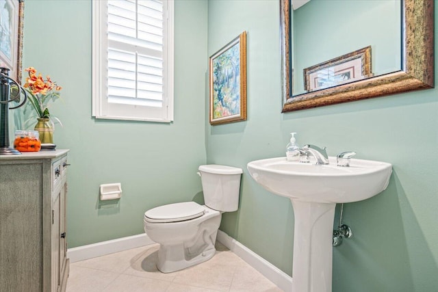 bathroom featuring toilet and tile patterned flooring