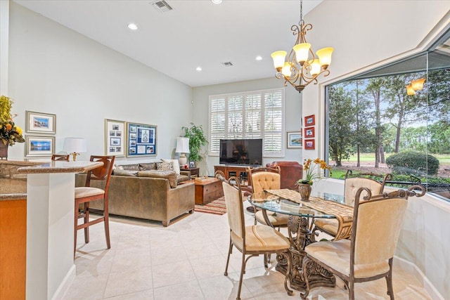 tiled dining room with a notable chandelier