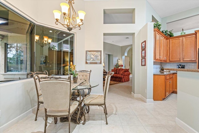 dining area featuring light tile patterned flooring and an inviting chandelier