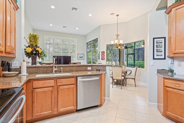 kitchen with a chandelier, light tile patterned flooring, sink, stone countertops, and stainless steel appliances