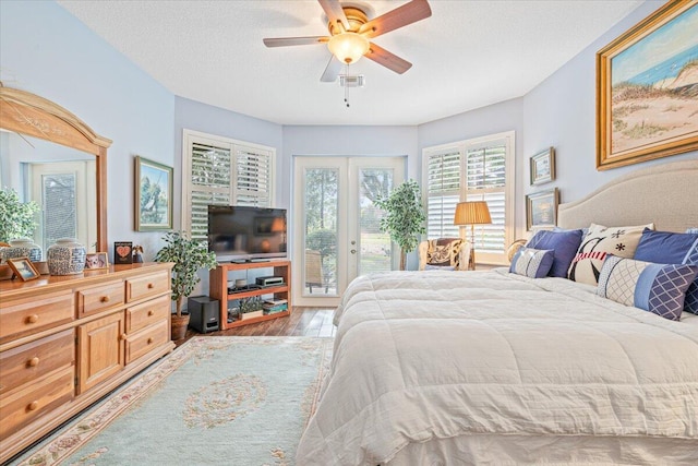 bedroom with access to outside, a textured ceiling, light wood-type flooring, and ceiling fan