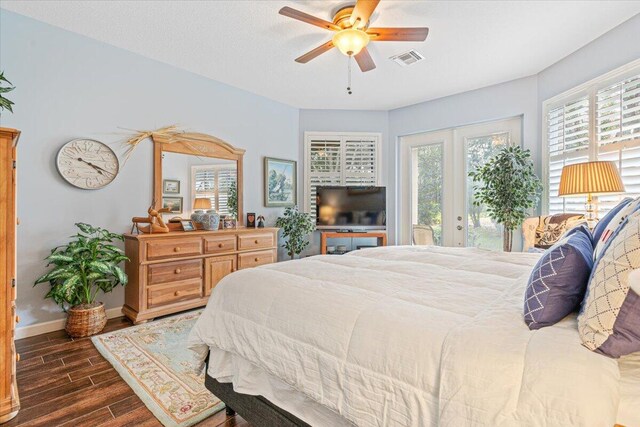 bedroom with access to outside, multiple windows, ceiling fan, and dark hardwood / wood-style flooring