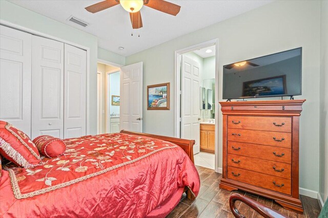 bedroom featuring ensuite bath, wood-type flooring, a closet, and ceiling fan