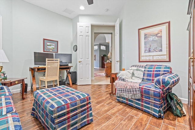 interior space with ceiling fan and wood-type flooring