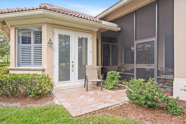 entrance to property featuring french doors and a patio area