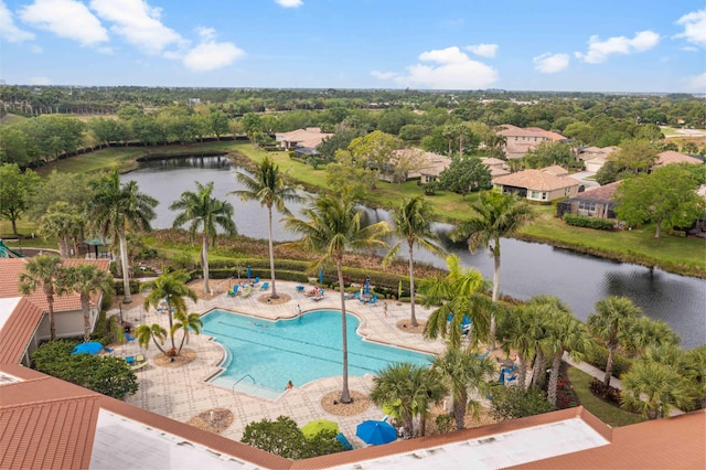 view of swimming pool featuring a water view and a patio