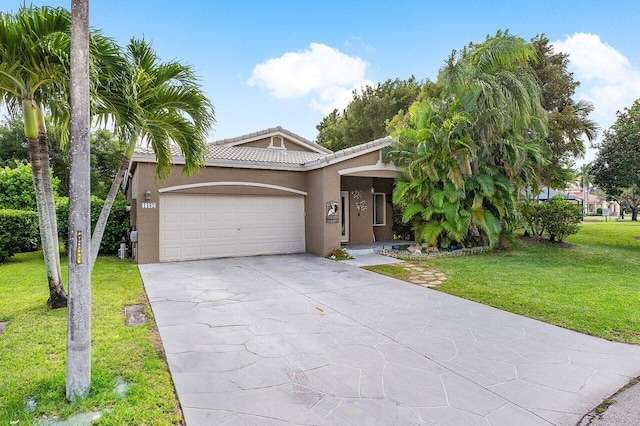 view of front of home featuring a front yard and a garage