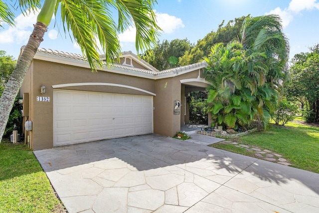 view of front of house with a garage and a front lawn