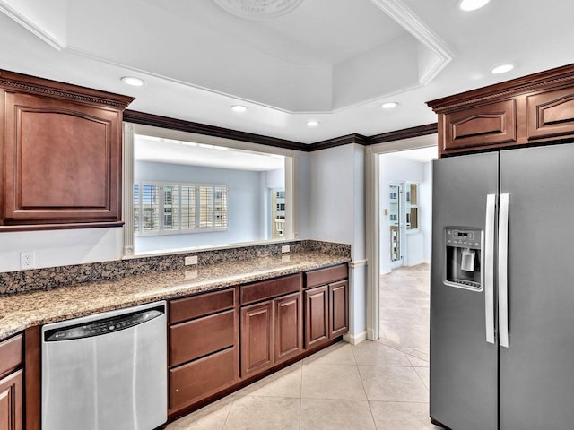 kitchen featuring appliances with stainless steel finishes, ornamental molding, and light tile patterned floors