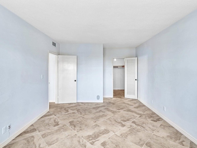 empty room featuring a textured ceiling