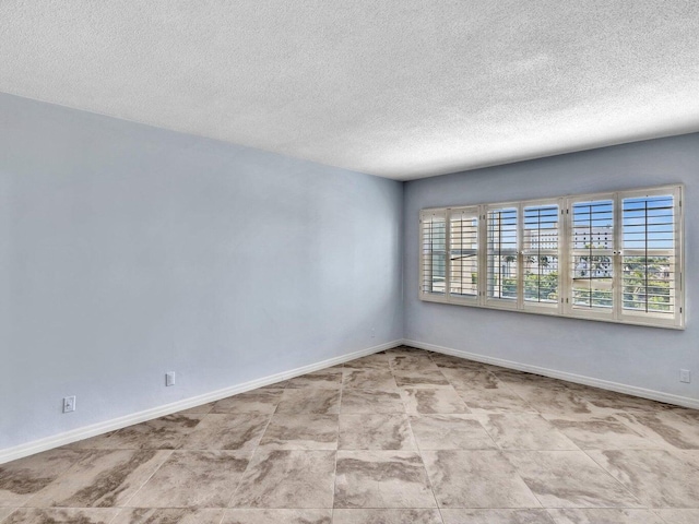 empty room featuring a healthy amount of sunlight and a textured ceiling