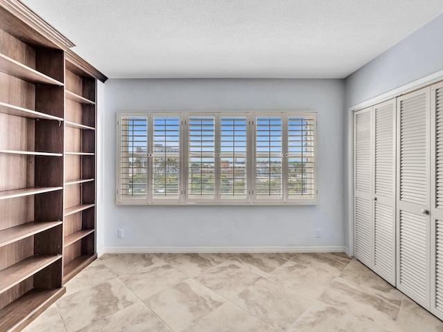 unfurnished bedroom featuring a textured ceiling