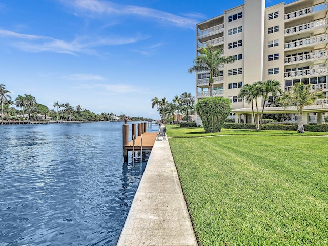 dock area featuring a lawn and a water view