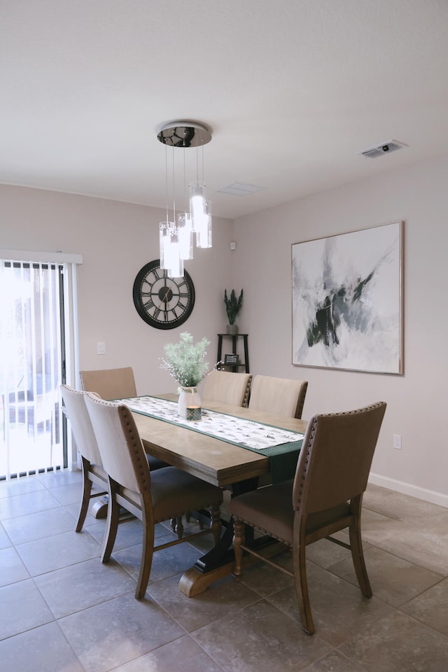 dining space featuring light tile patterned floors