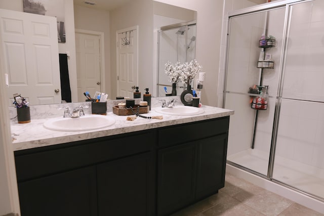 bathroom with vanity, a shower with shower door, and tile patterned floors