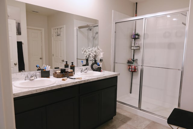 bathroom featuring vanity, tile patterned floors, and walk in shower