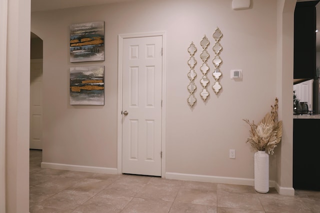 hallway with light tile patterned floors