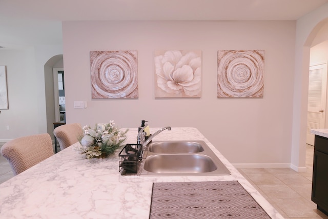 kitchen featuring sink and light tile patterned floors