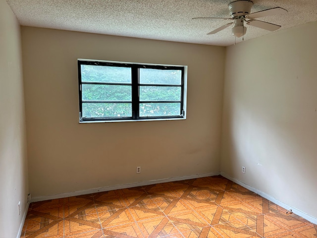 empty room featuring a textured ceiling and ceiling fan