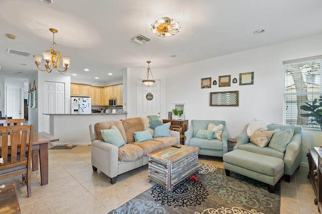 tiled living room featuring a chandelier