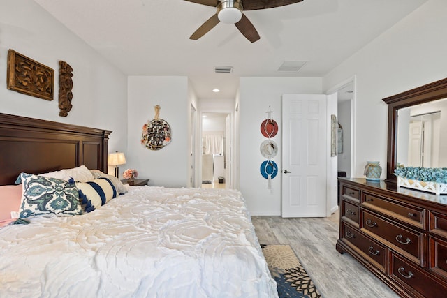 bedroom with ceiling fan and light hardwood / wood-style floors