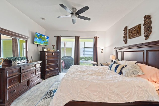 bedroom with ceiling fan, light wood-type flooring, and access to outside