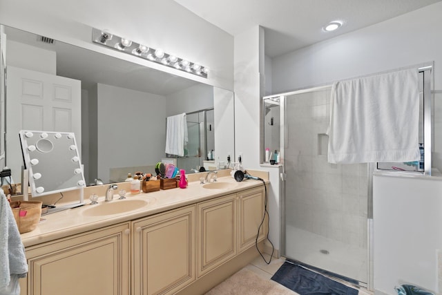 bathroom with tile patterned flooring, vanity, and a shower with shower door